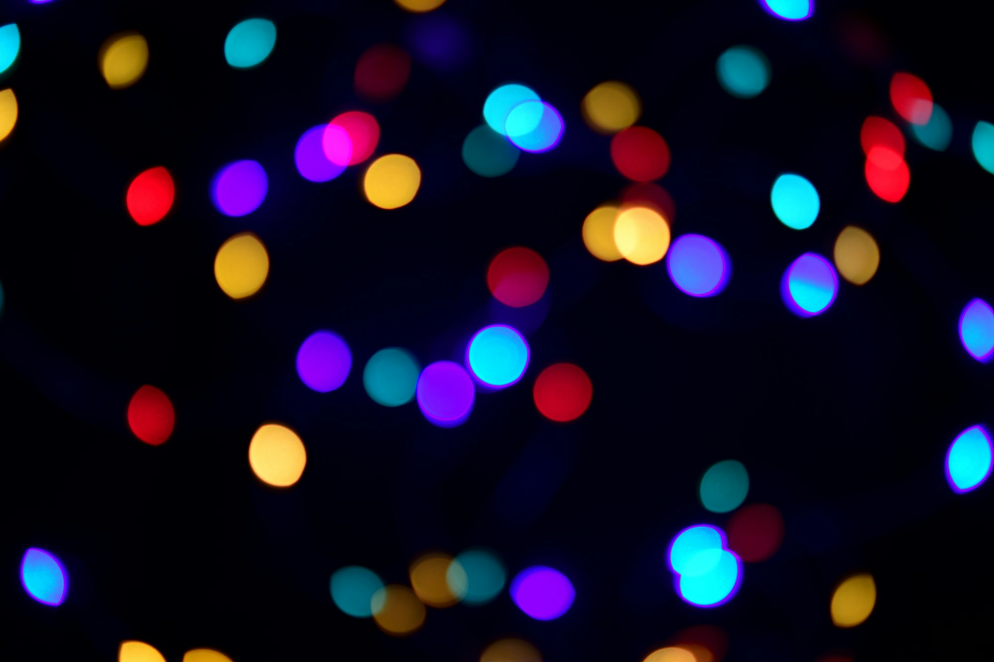 Abstract bokeh lights on dark background than can also be used as overlay.