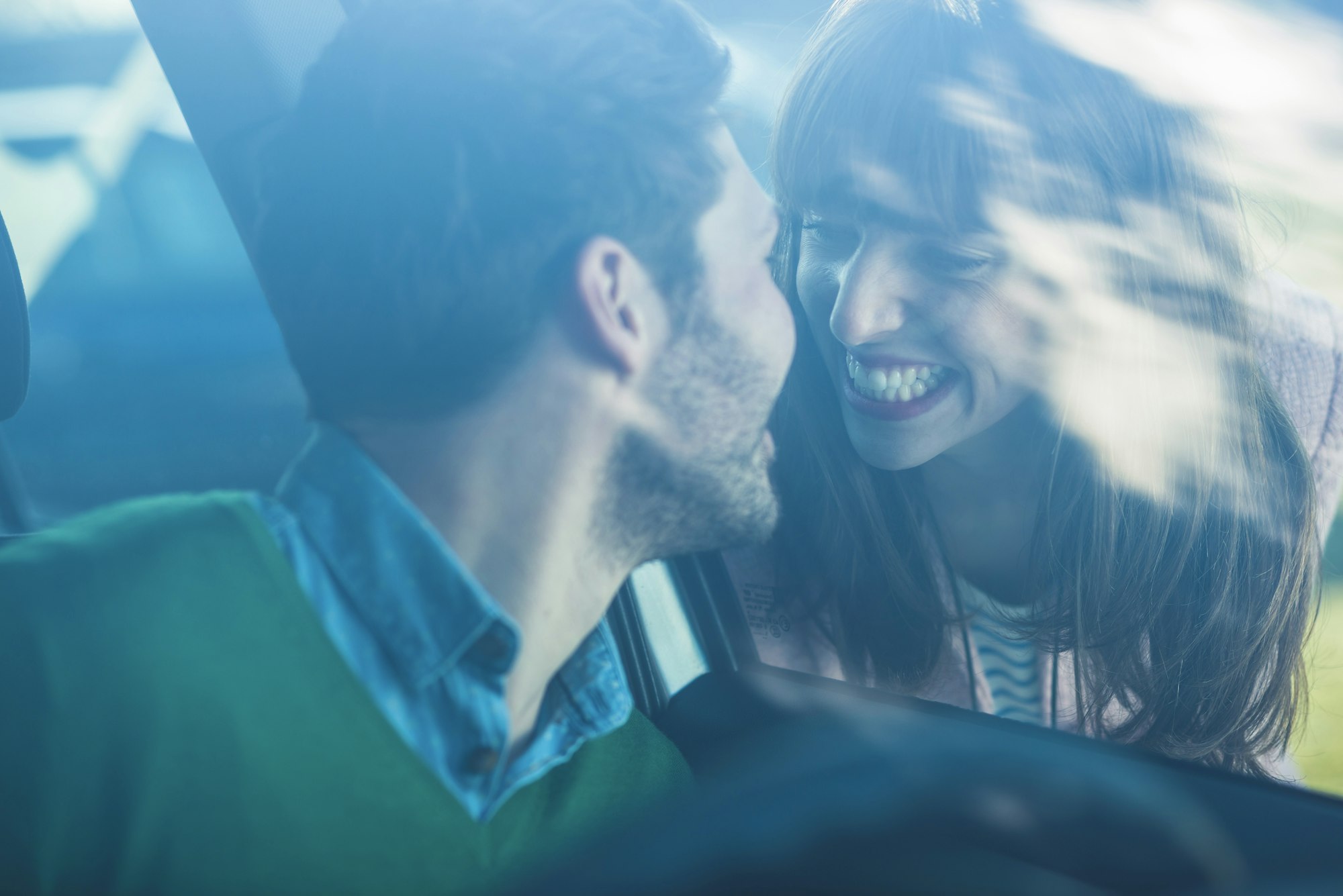 Couple saying farewell through windscreen