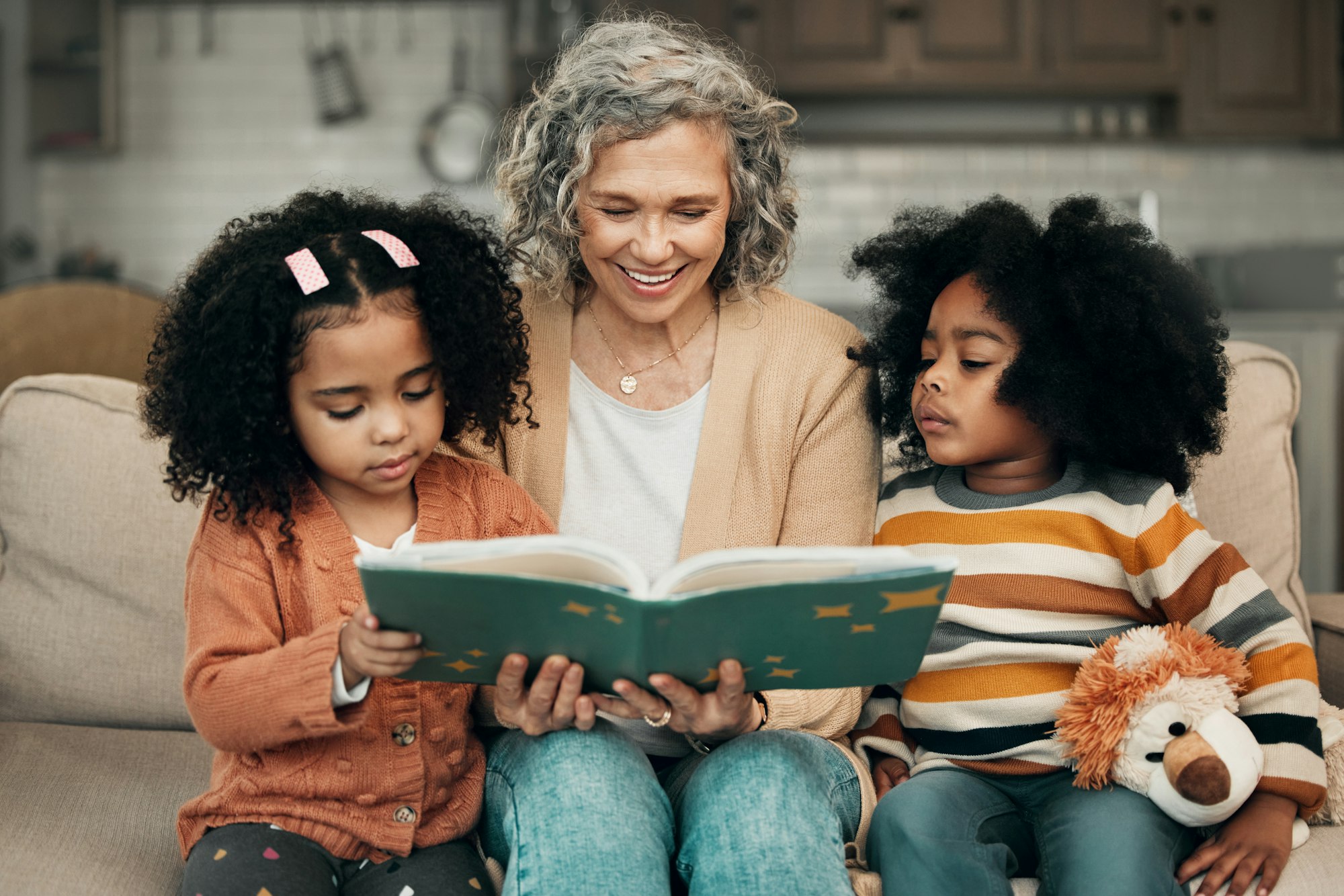 Family kids, book and grandma reading fantasy storybook, story or bond on home living room sofa. Lo