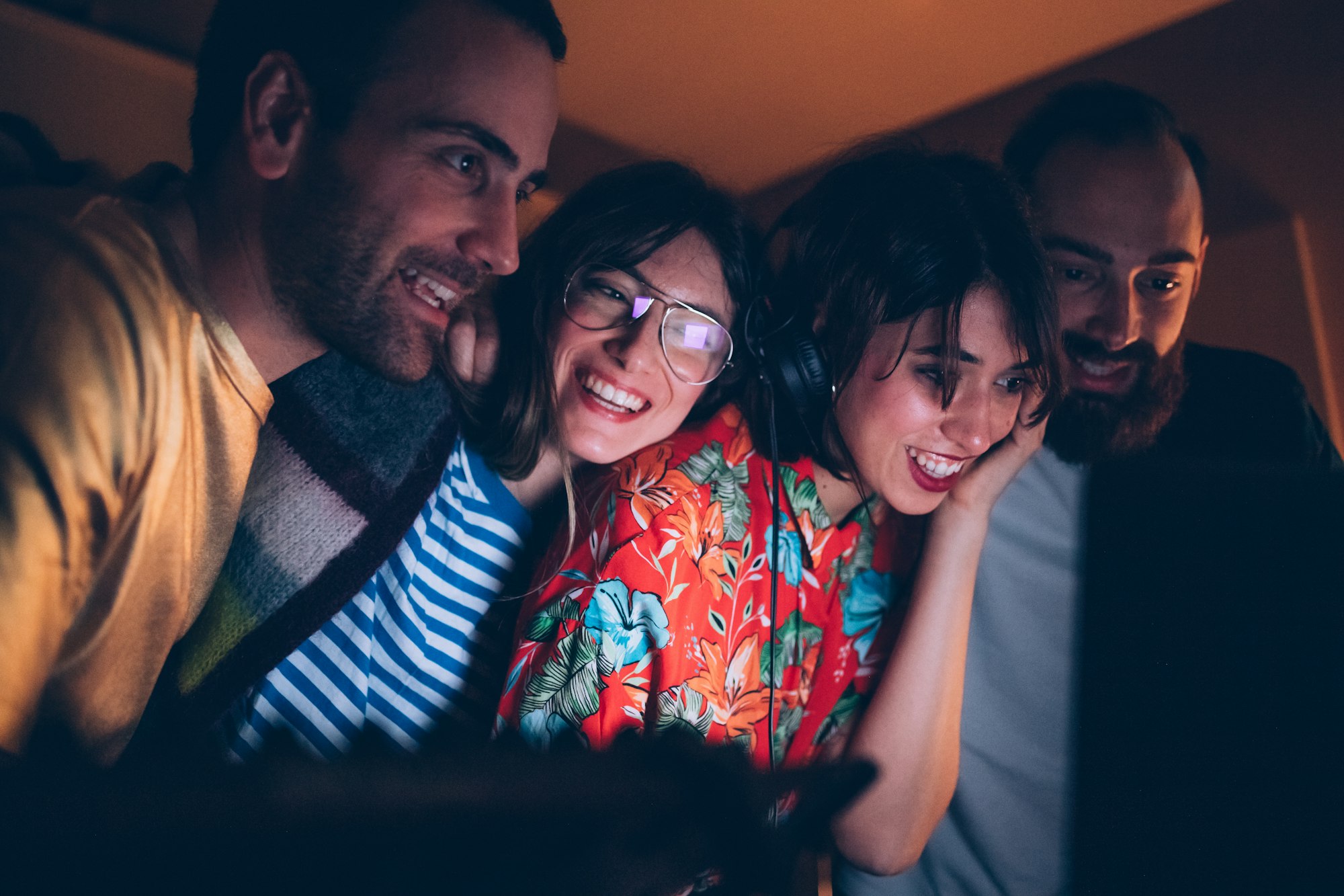 Four young adult together listening music together