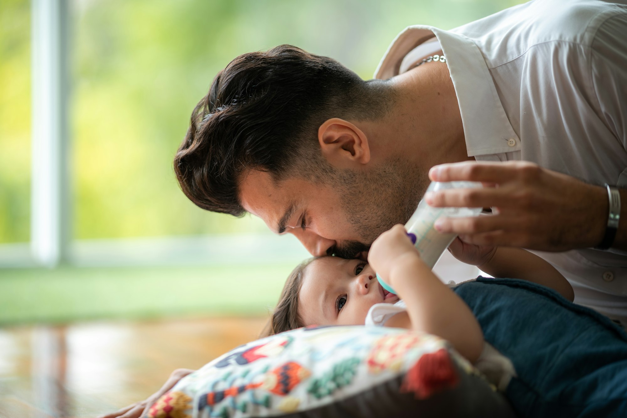 Middle age Caucasian father living with newborn crawling baby, Parent holding child daughter son