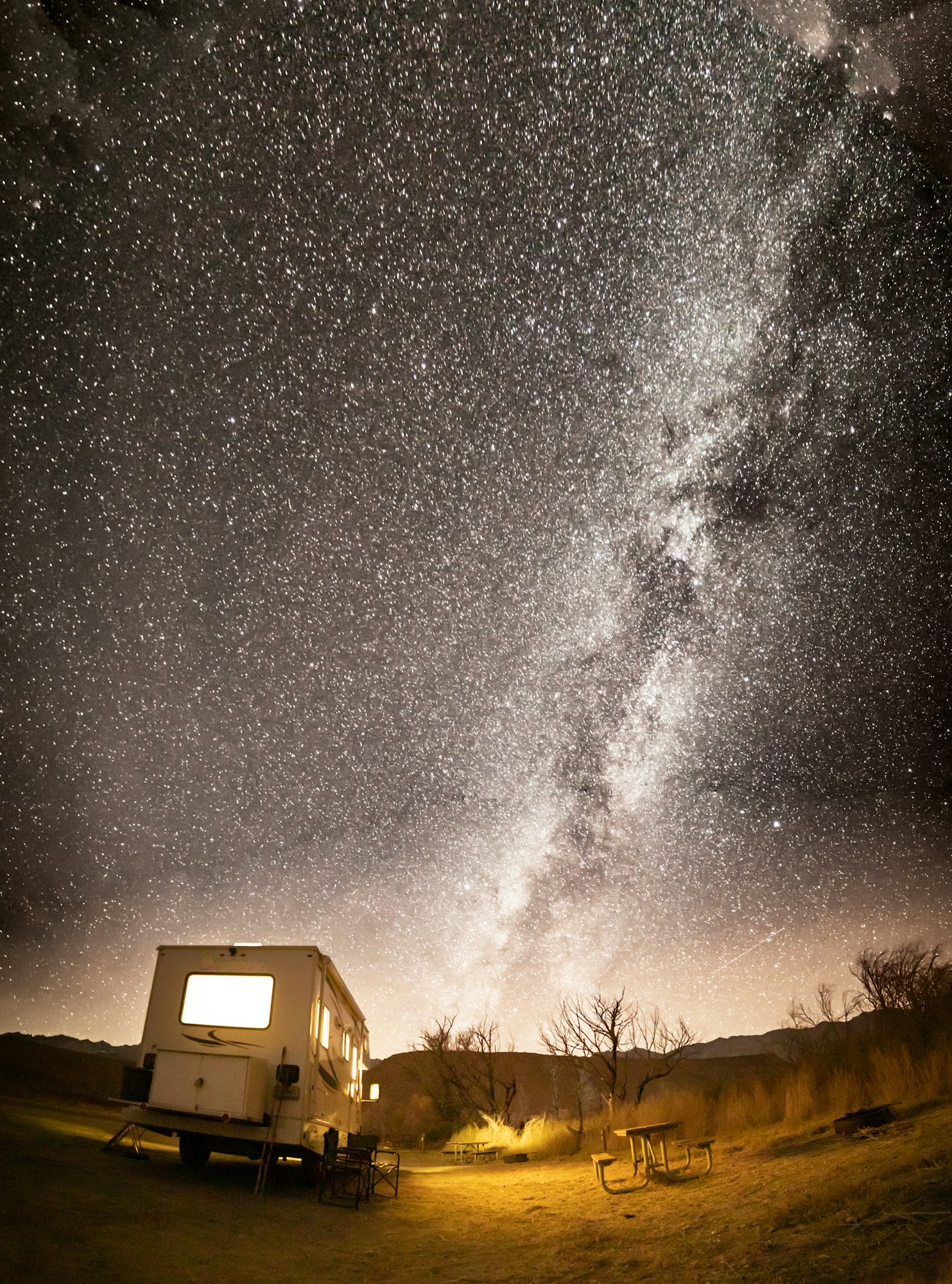 RV camped under milky way starry night sky