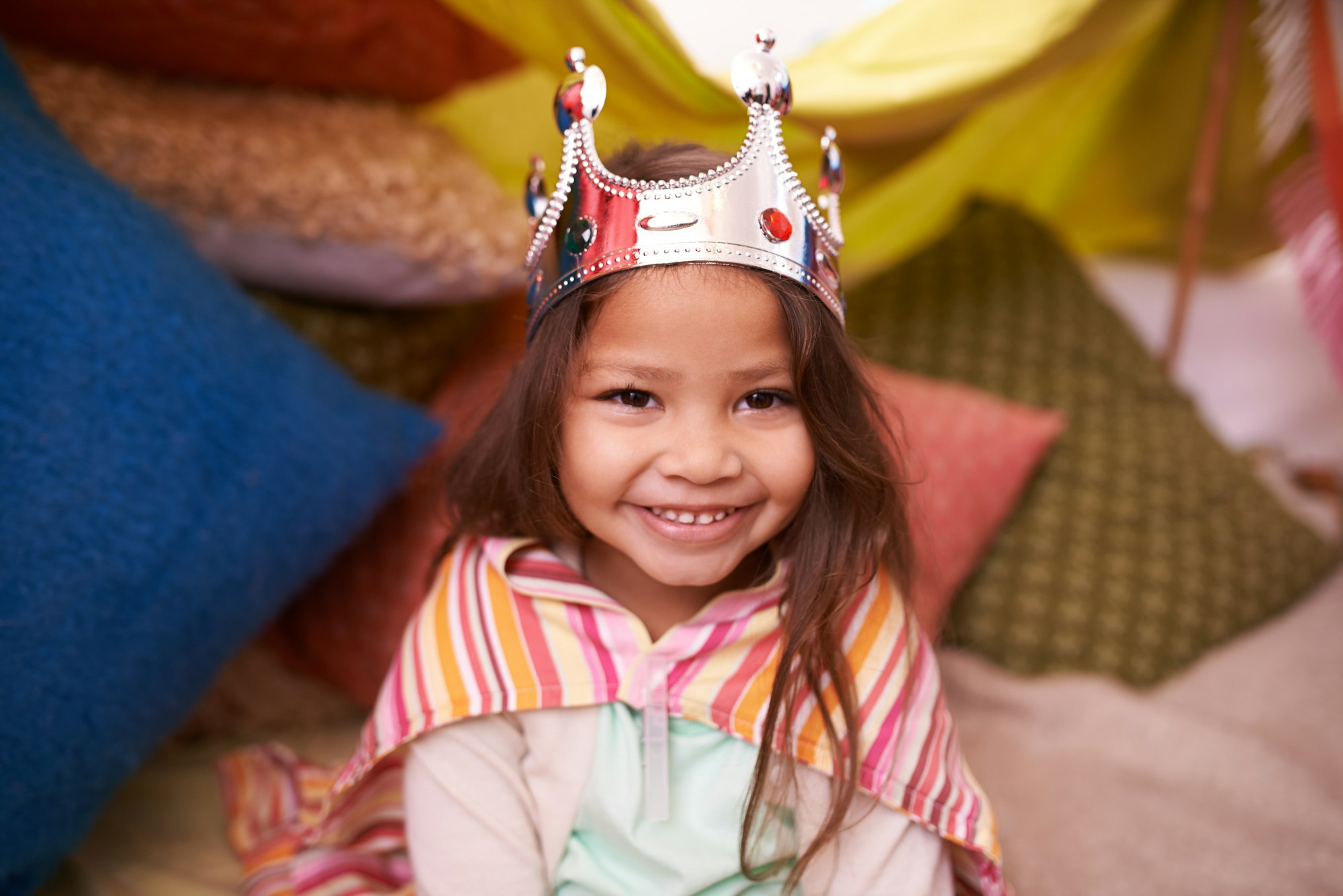 Shes a little princess. A cute little girl dressed up as a princess while playing at home.