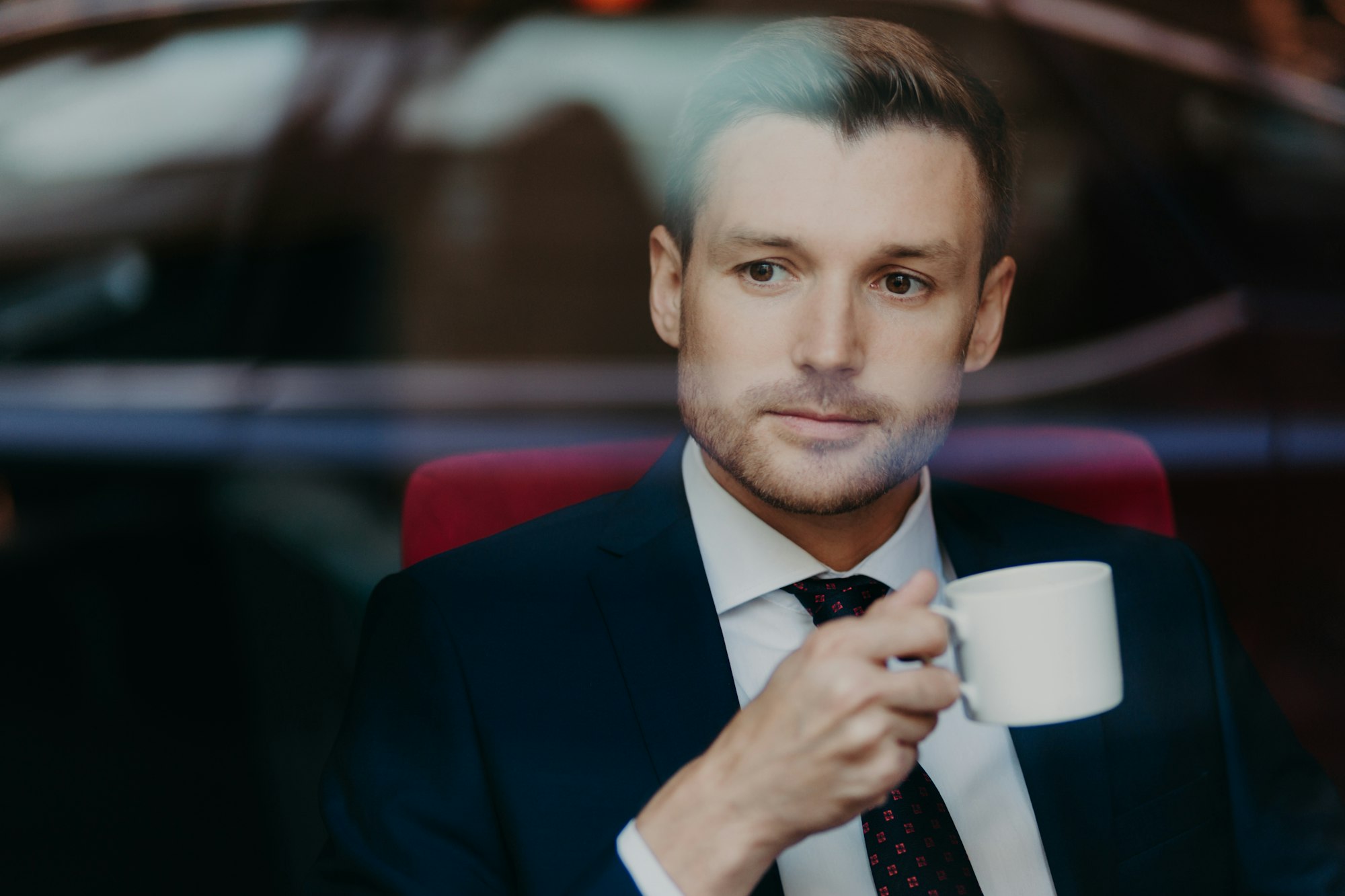 Successful prosperous male entrepreneur with stubble, thinks about something