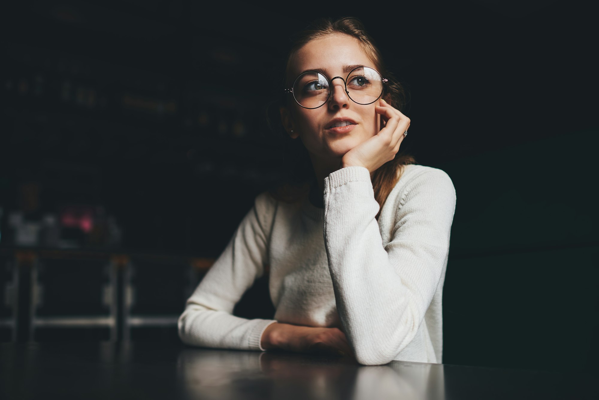 Young female with dreamy sight looking away