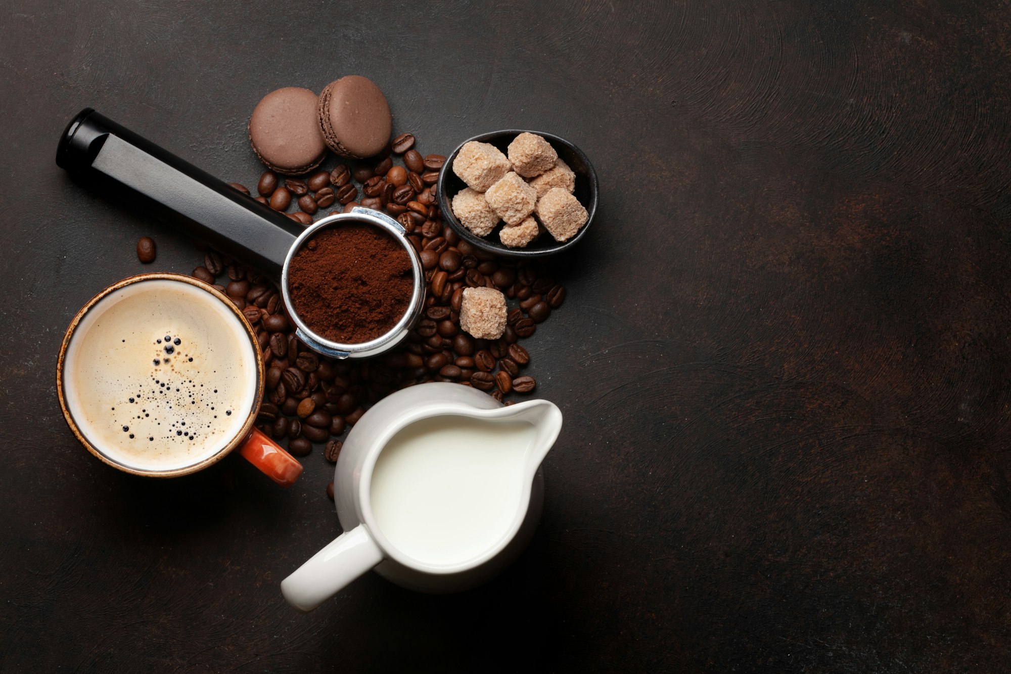 Fresh cappuccino coffee, roasted coffee beans and milk