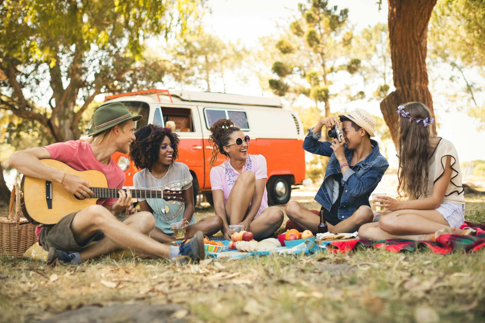 Man photographing friend playing guitar