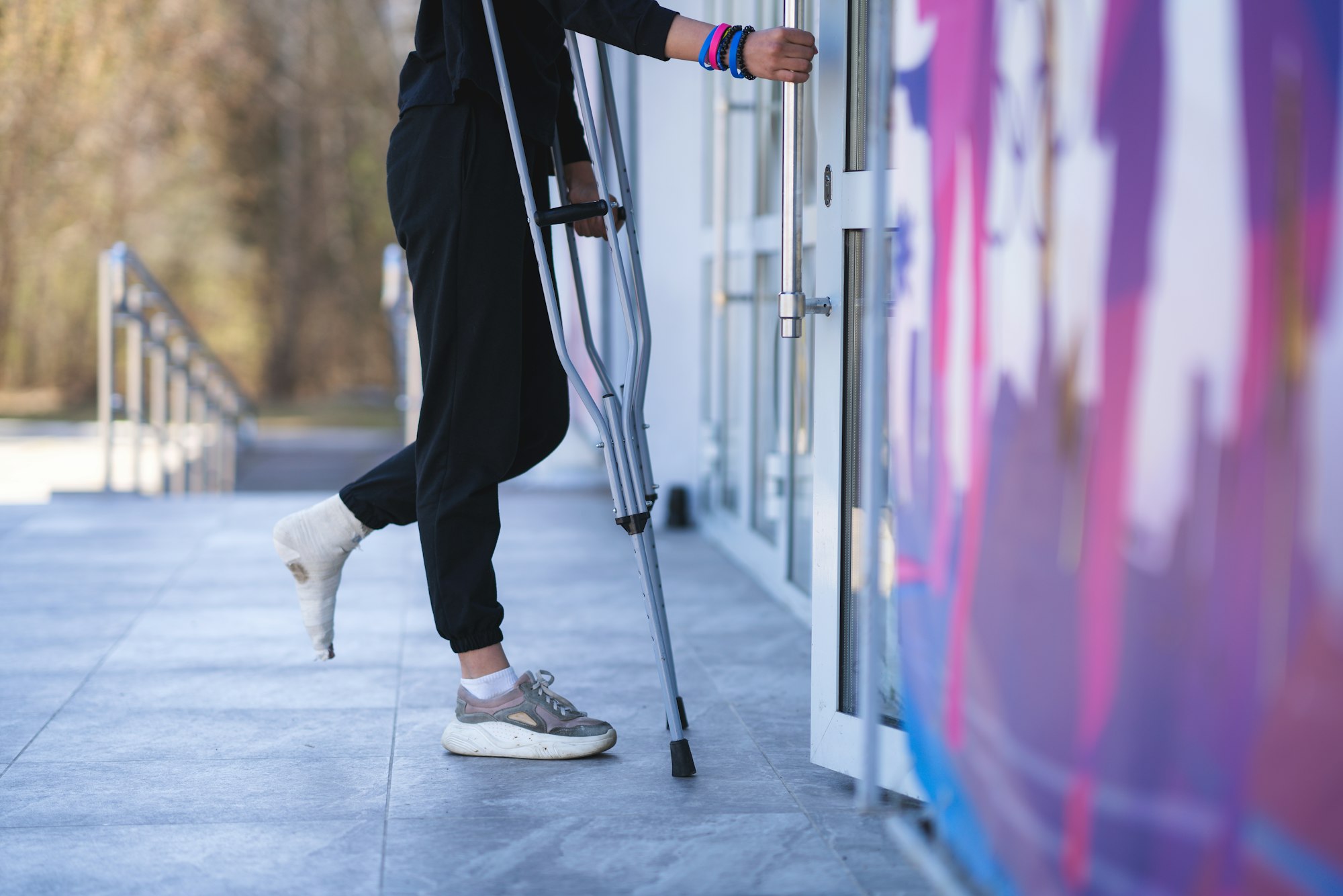 Young woman with a broken ankle on crutches.